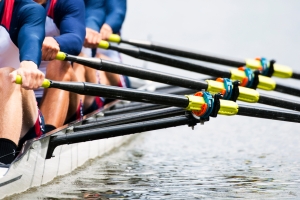 Close up of a men's quadruple skulls rowing team, seconds after the start of their race